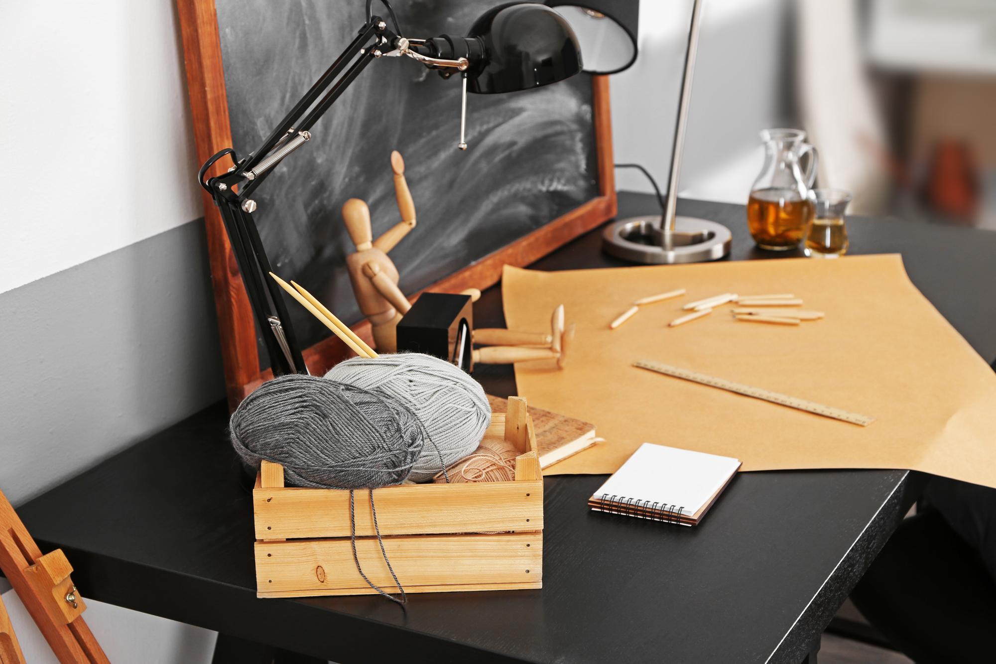 Workshop table with threads, hoops and hand tools