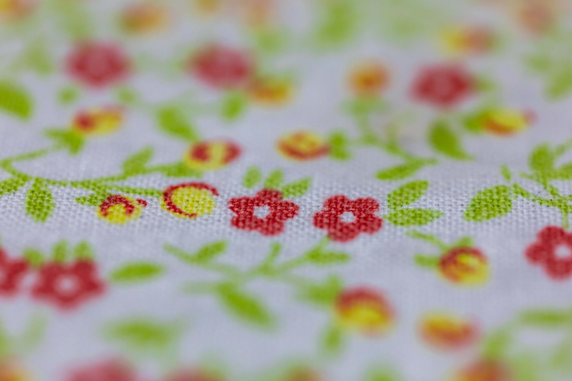 Detail of colorful embroidered sampler on linen