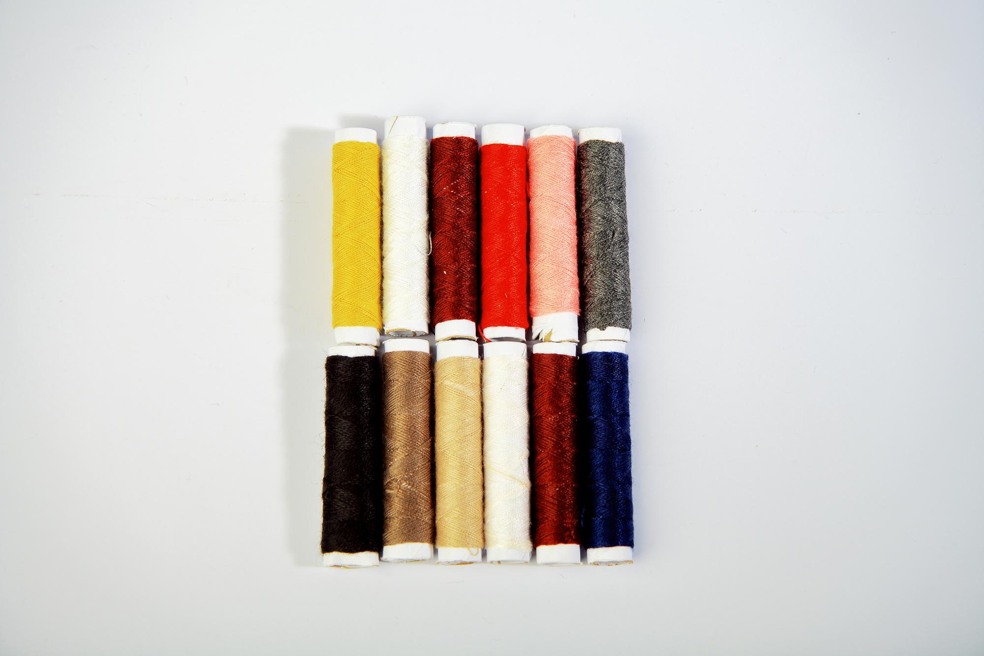 Stack of embroidered fabric samples on table